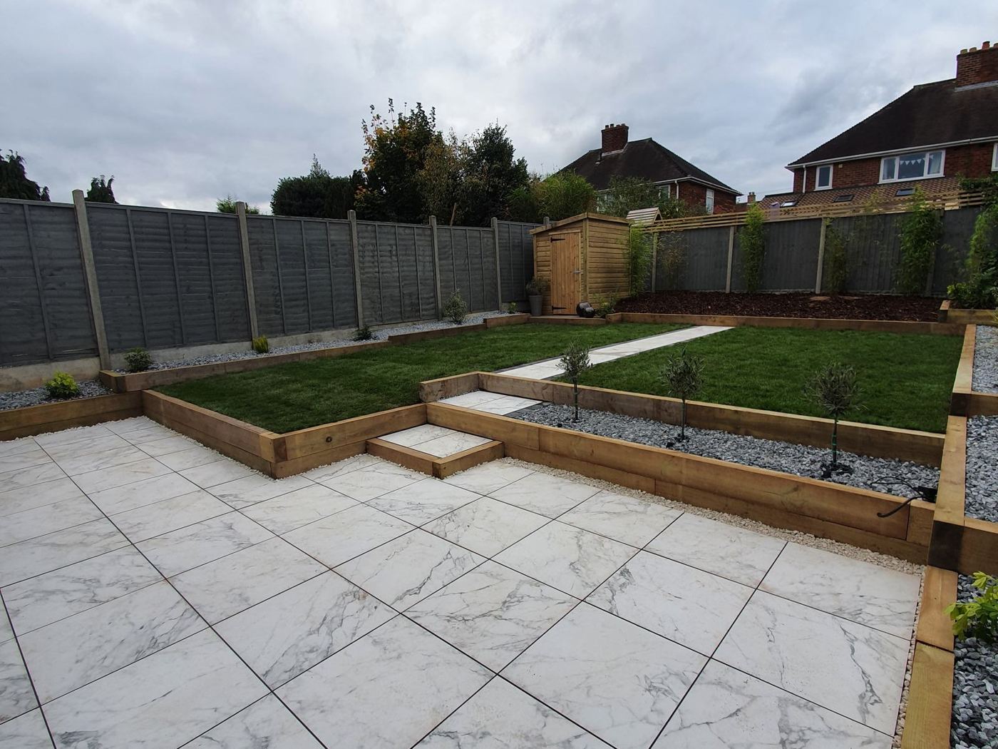 After: Finished porcelain patio with raised sleeper lawn in Sutton Coldfield