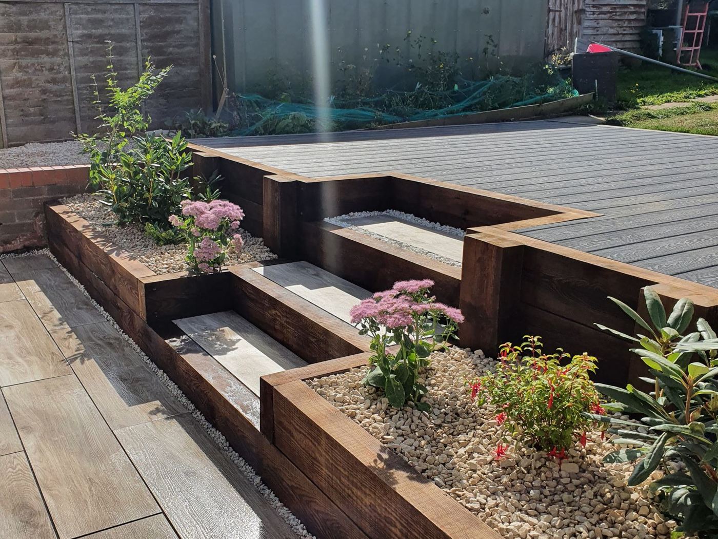 After: Finished tiered garden with porcelain steps, sleeper planters and grey composite decking in Tamworth