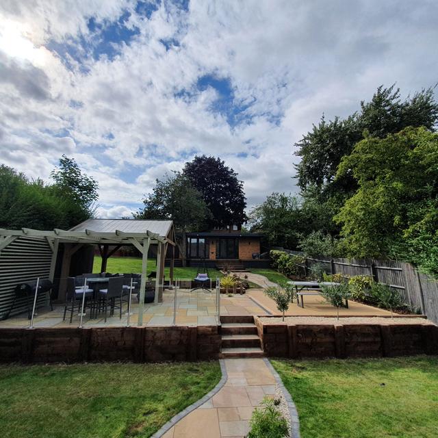 Landscaped tiered garden with gazebo and sandstone path