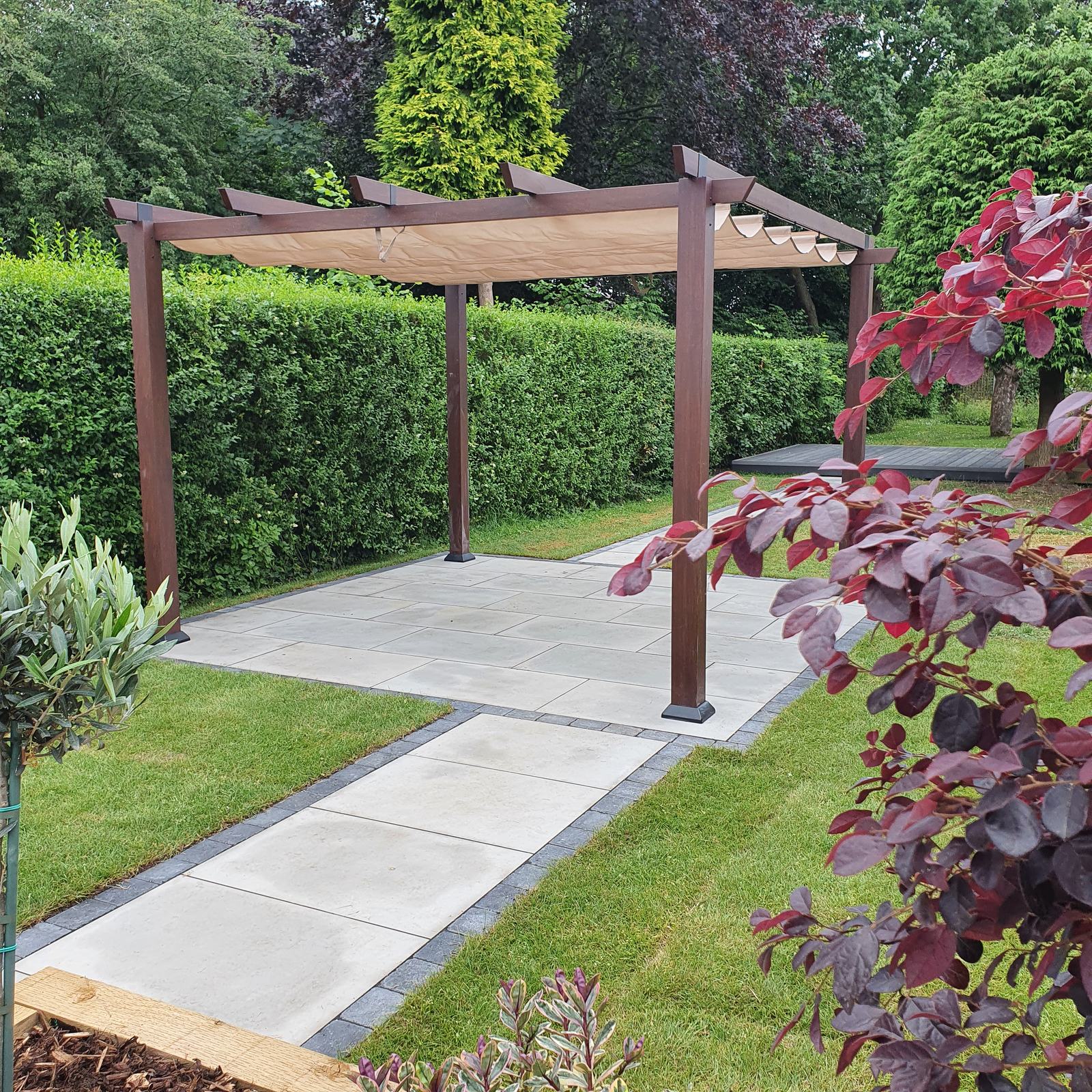 Porcelain path and pergola with new lawn and planting